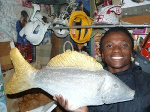 Luyanda, multi-talented artist from Masiphumelele with one of hie sculptures